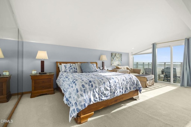 carpeted bedroom featuring access to exterior, a water view, and lofted ceiling