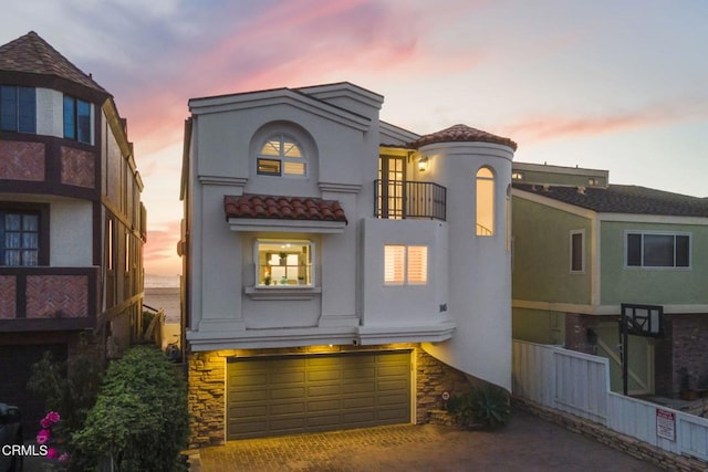 view of front facade with a balcony and a garage