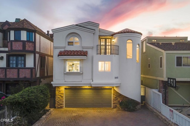 view of front of property with a balcony and a garage