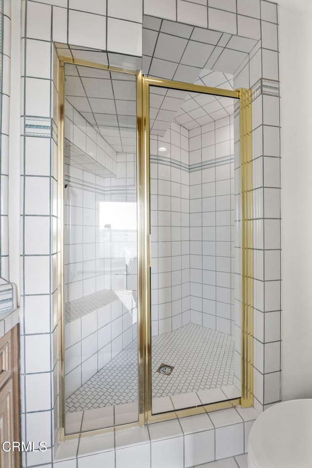 bathroom with toilet and an enclosed shower