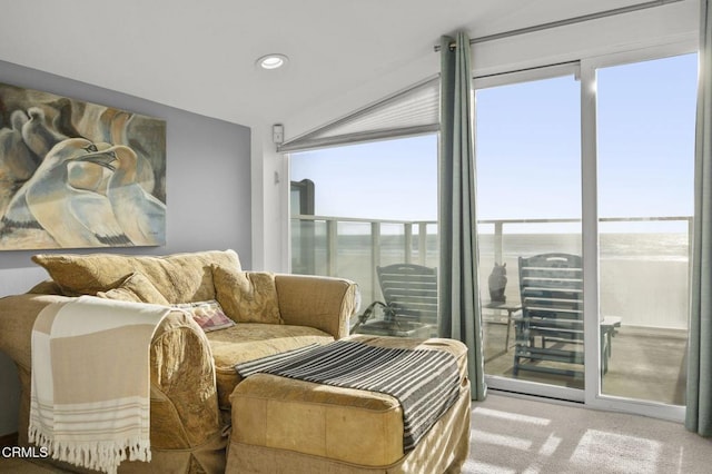 living area with carpet and a water view