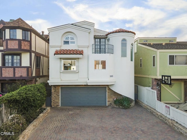 view of front of home with a garage and a balcony