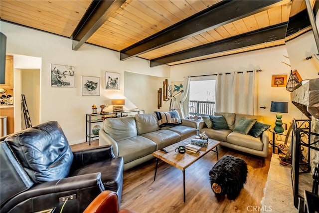 living room featuring beamed ceiling, light hardwood / wood-style floors, and wooden ceiling