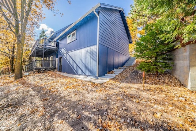 view of side of property with a wooden deck