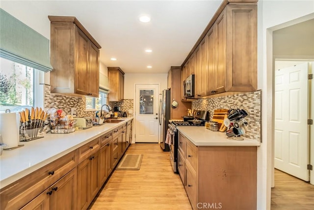 1181 Voltaire Dr, Lake Arrowhead, CA 92352 - kitchen with stainless steel appliances, light wood-type flooring, light countertops, backsplash, and recessed lighting