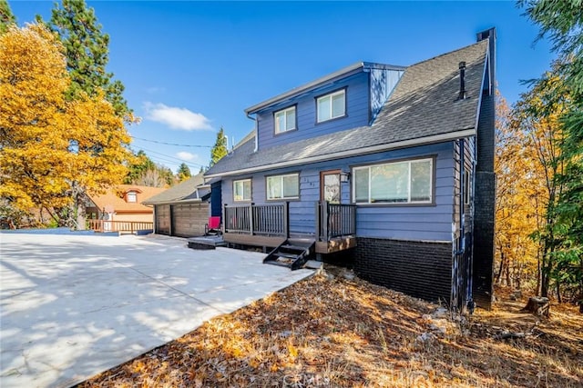 1181 Voltaire Dr, Lake Arrowhead, CA 92352 - bungalow-style home featuring a patio area, a chimney, roof with shingles, and a detached garage