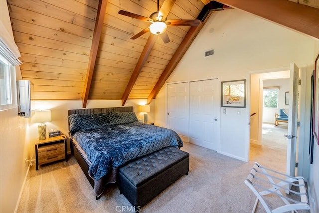 carpeted bedroom with beam ceiling, a closet, ceiling fan, and wooden ceiling