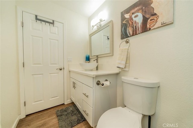 bathroom featuring hardwood / wood-style floors, vanity, and toilet