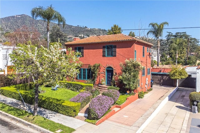 mediterranean / spanish home featuring a mountain view