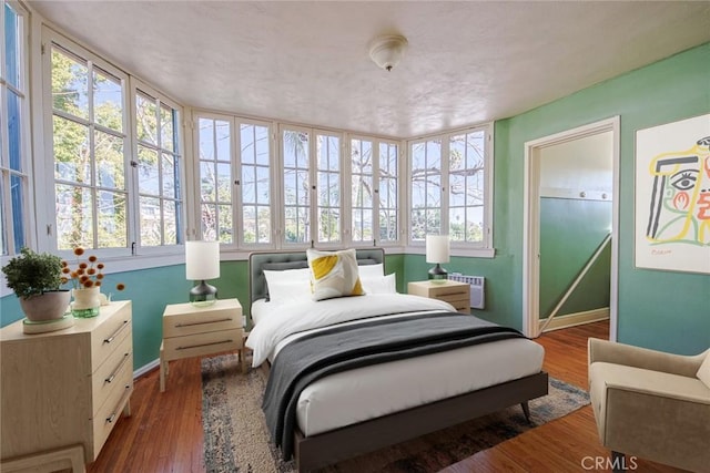 bedroom featuring dark hardwood / wood-style flooring