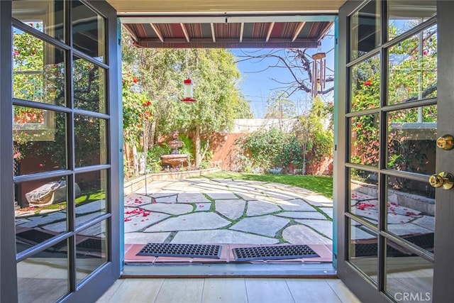 doorway with hardwood / wood-style floors and a wealth of natural light