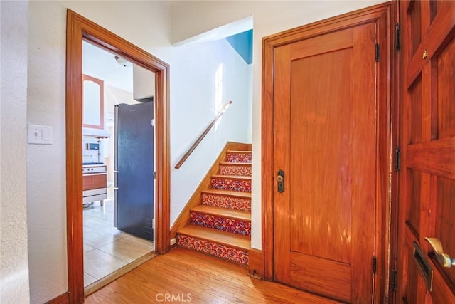 staircase with hardwood / wood-style floors