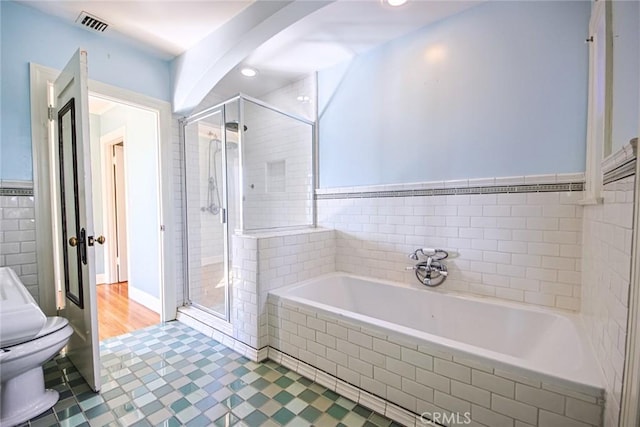 bathroom with separate shower and tub and toilet