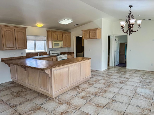 kitchen with hanging light fixtures, a notable chandelier, kitchen peninsula, vaulted ceiling, and white appliances