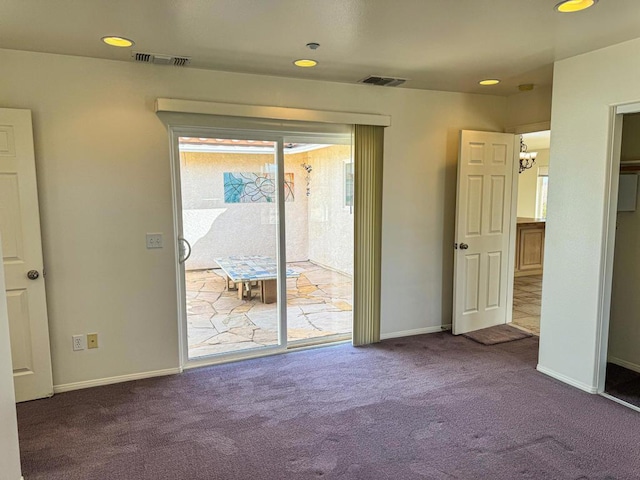 unfurnished bedroom featuring access to outside, carpet floors, and a notable chandelier