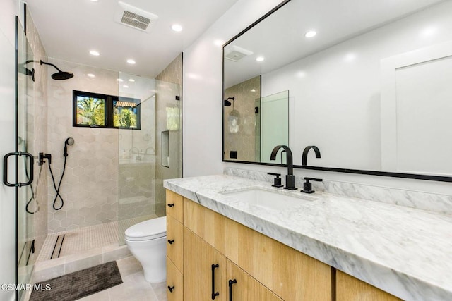 bathroom with tile patterned floors, vanity, toilet, and an enclosed shower