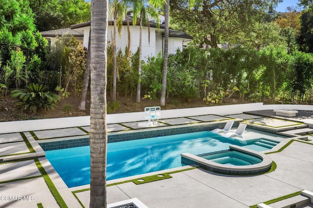 view of pool with an in ground hot tub