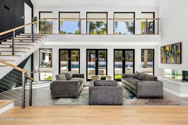 living room with french doors, plenty of natural light, and hardwood / wood-style floors