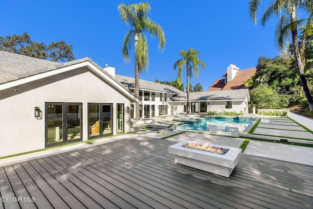 wooden deck featuring a fire pit