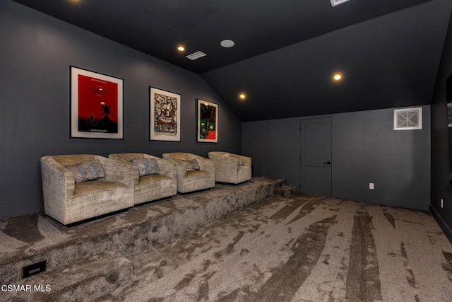 cinema with carpet flooring and vaulted ceiling