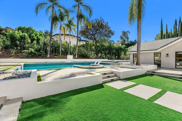 view of swimming pool featuring a yard, an in ground hot tub, and a patio