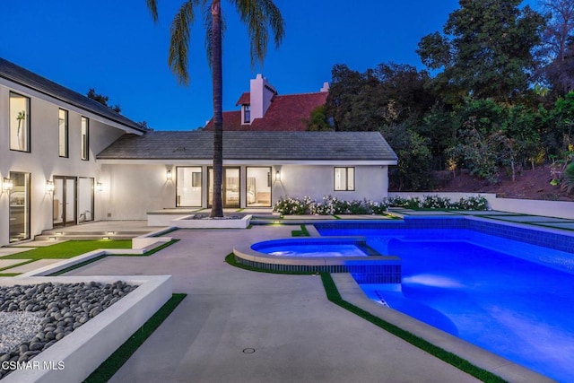 view of pool with a patio area and an in ground hot tub