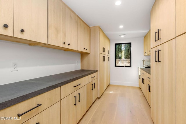 kitchen featuring light brown cabinets and light wood-type flooring