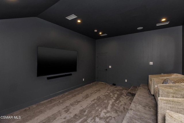 home theater room featuring carpet flooring and lofted ceiling