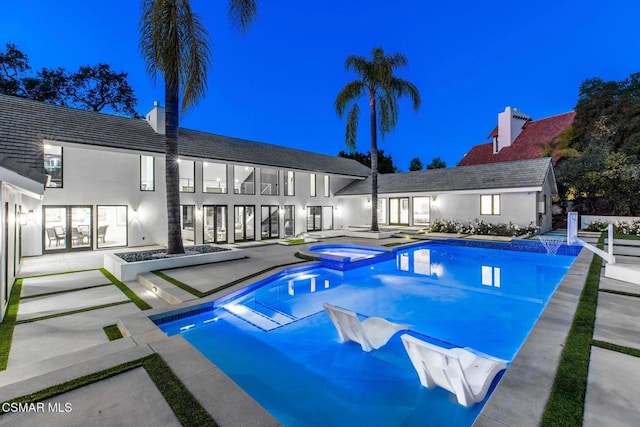 view of pool featuring an in ground hot tub and a patio area