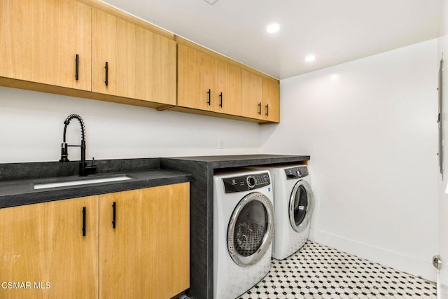 laundry room with cabinets, independent washer and dryer, and sink