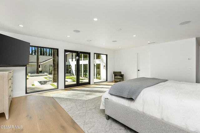 bedroom with access to exterior, french doors, and light hardwood / wood-style flooring