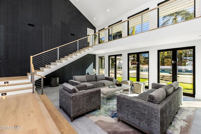 living room featuring high vaulted ceiling and french doors