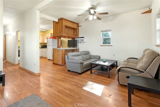 living room with light hardwood / wood-style floors, an AC wall unit, and ceiling fan