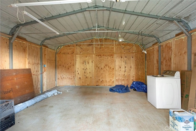 garage featuring washer / clothes dryer and wooden walls