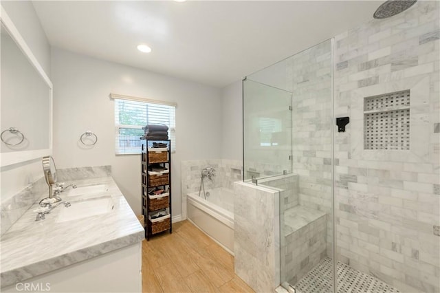 bathroom with vanity, independent shower and bath, and hardwood / wood-style flooring