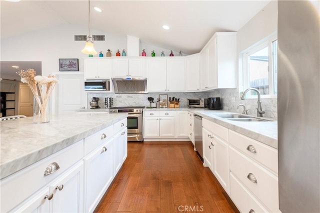 kitchen with white cabinetry, sink, dark hardwood / wood-style flooring, vaulted ceiling, and appliances with stainless steel finishes