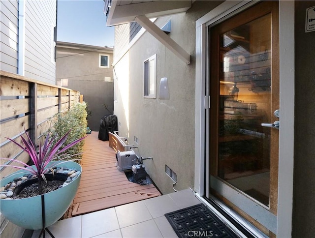 exterior space with stucco siding and fence