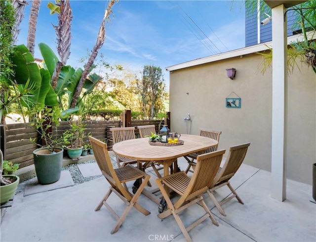 view of patio / terrace with outdoor dining space and fence