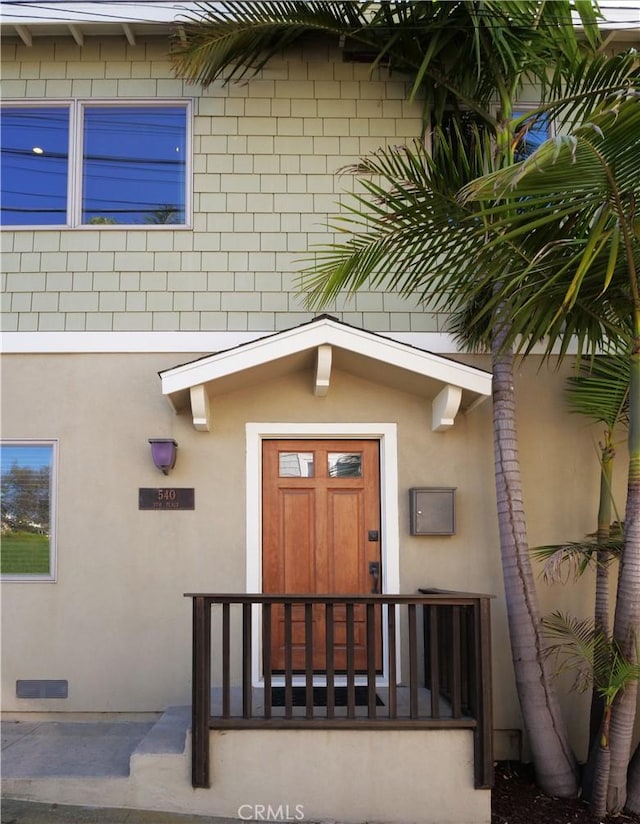 doorway to property with stucco siding