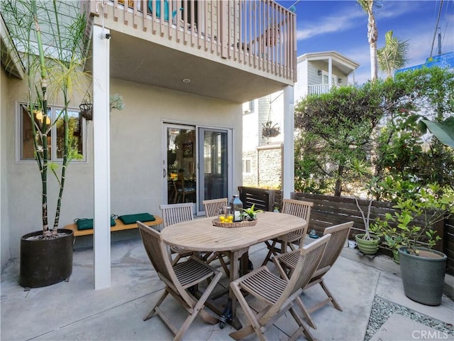 view of patio / terrace featuring a balcony and outdoor dining space