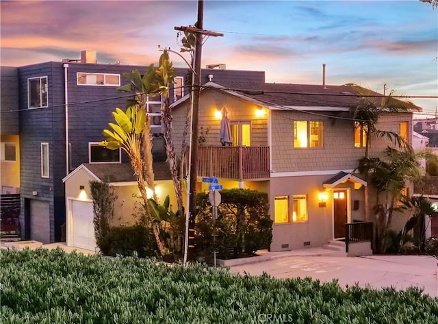 back of property featuring crawl space, stucco siding, and a balcony