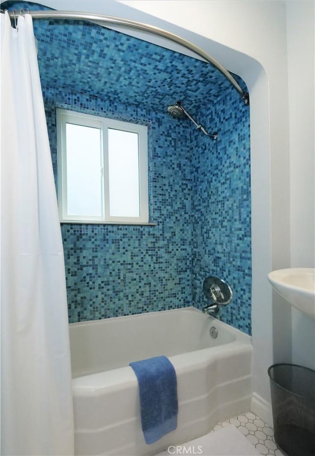 bathroom with tile patterned floors and shower / bath combo with shower curtain