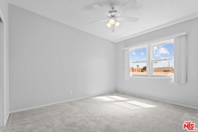 unfurnished room with carpet, a textured ceiling, and ceiling fan