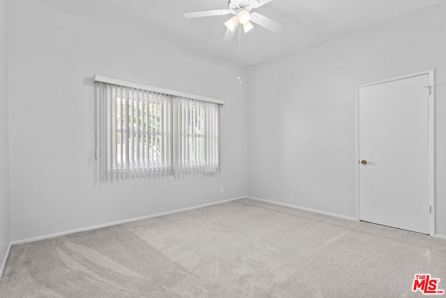 unfurnished room with ceiling fan and light colored carpet