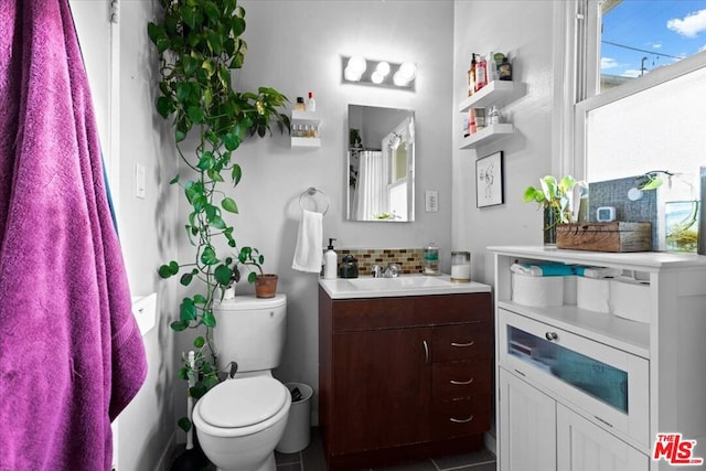 bathroom with tile patterned floors, vanity, and toilet