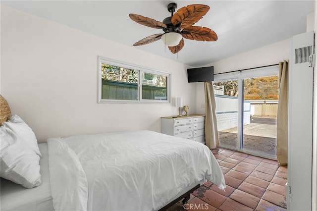 bedroom featuring ceiling fan, access to exterior, light tile patterned floors, and multiple windows