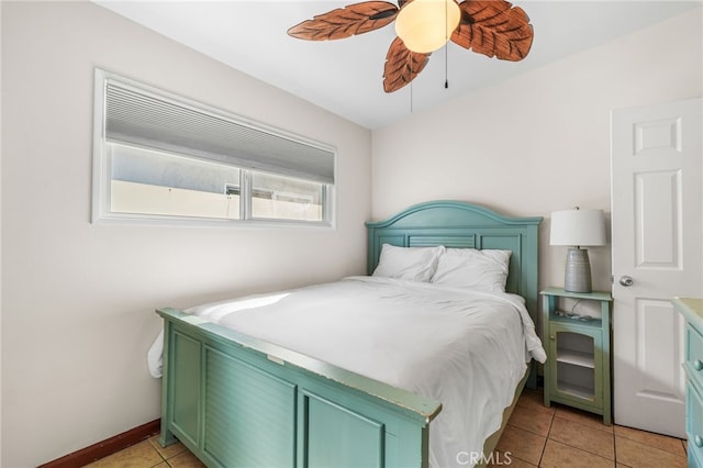 tiled bedroom featuring ceiling fan