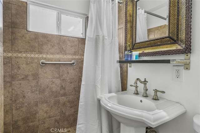 bathroom with sink and walk in shower