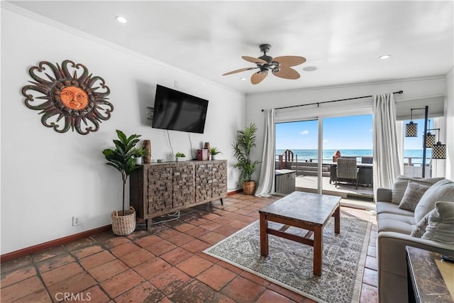 living room featuring ceiling fan and ornamental molding