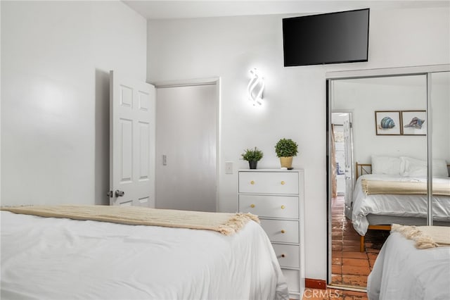 bedroom with hardwood / wood-style floors and a closet